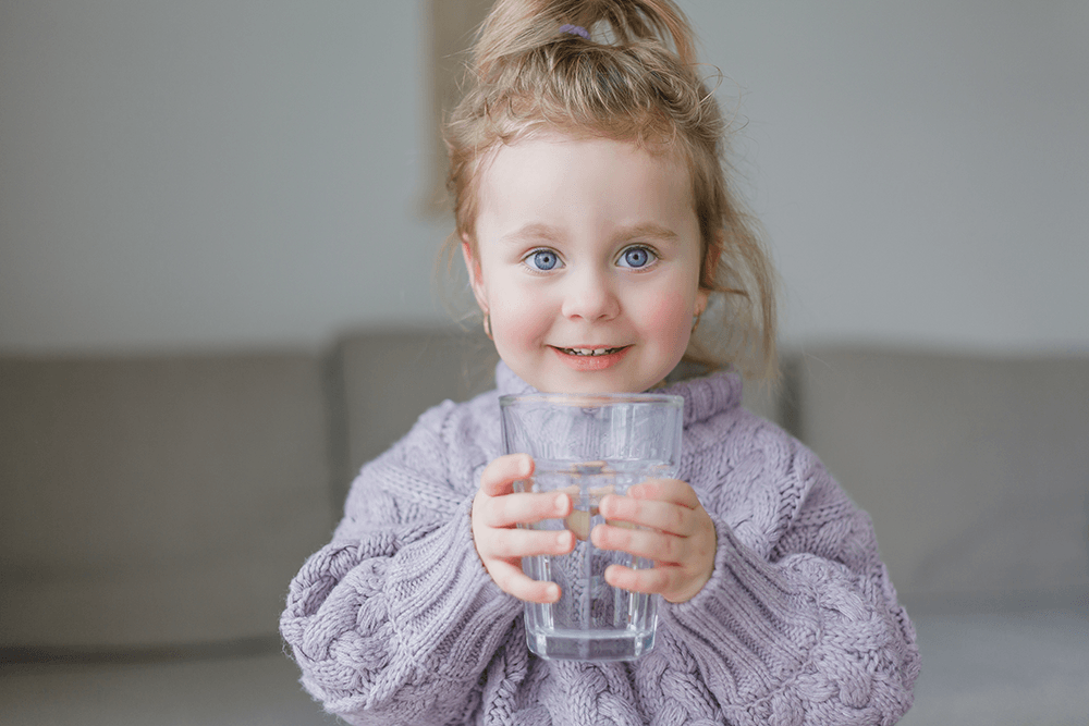 a-little-girl-holds-a-glass-of-water-drinks-2021-10-01-17-39-50-utc