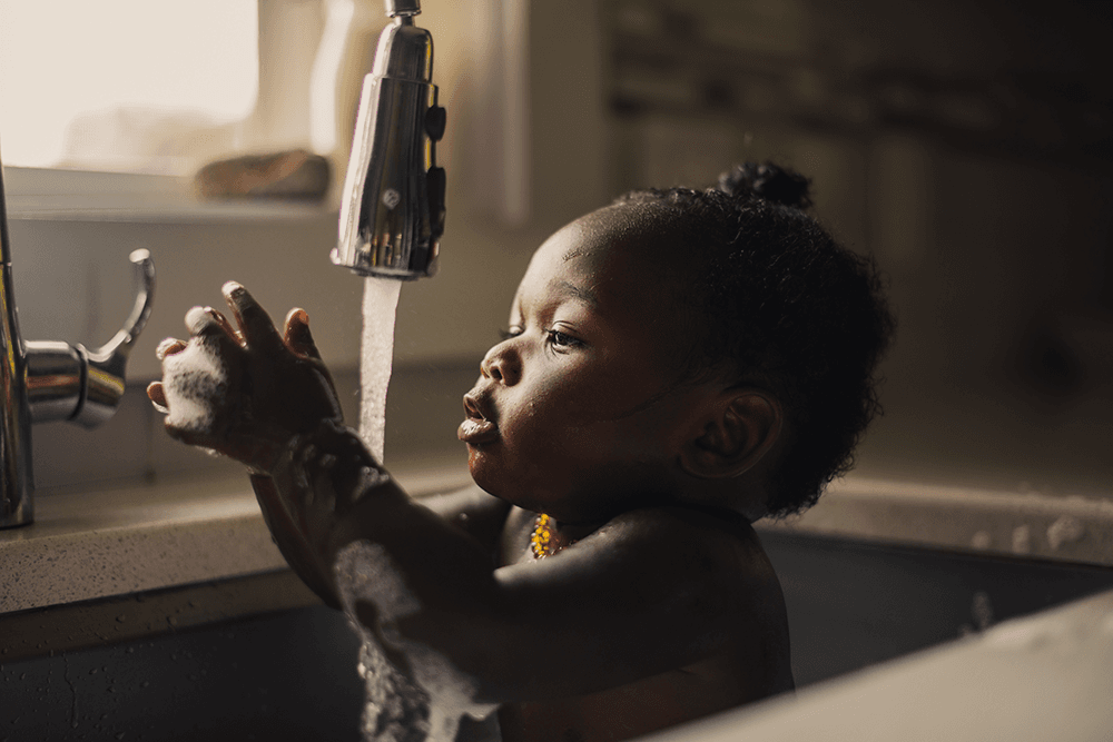 baby-girl-playing-in-sink-taking-a-bath-2021-08-29-14-24-15-utc