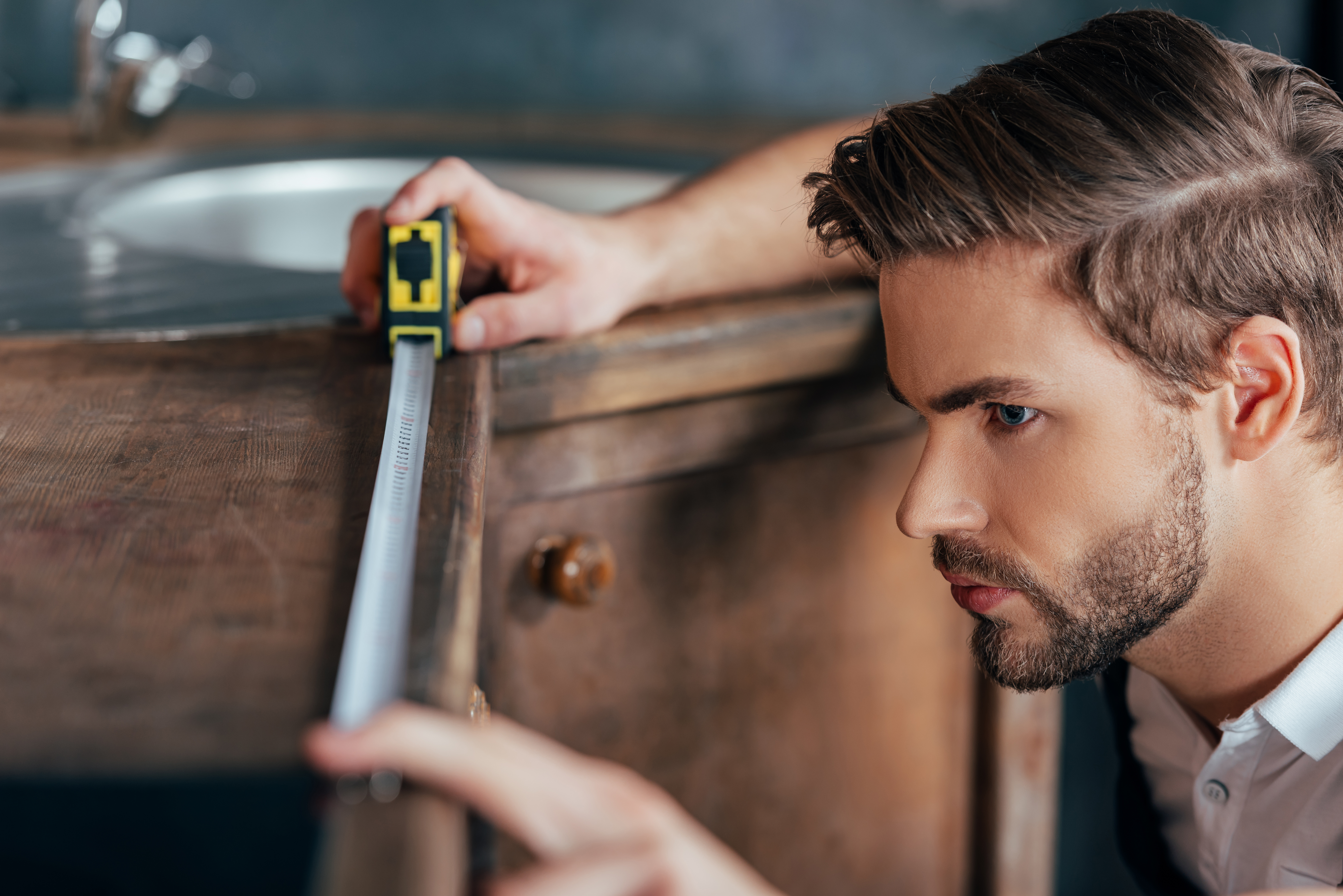 close-up-view-of-young-foreman-measuring-kitchen-f-2021-08-29-19-37-22-utc