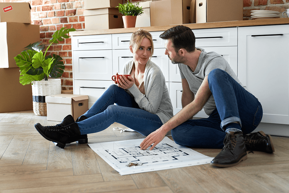 couple-sitting-on-the-floor-in-their-new-apartment-2021-09-02-01-07-19-utc