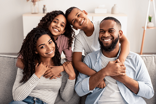 portrait-of-happy-black-family-smiling-at-home-2021-09-02-22-26-34-utc