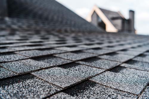 selective-focus-of-grey-shingles-on-rooftop-of-bui-7K3R6FE
