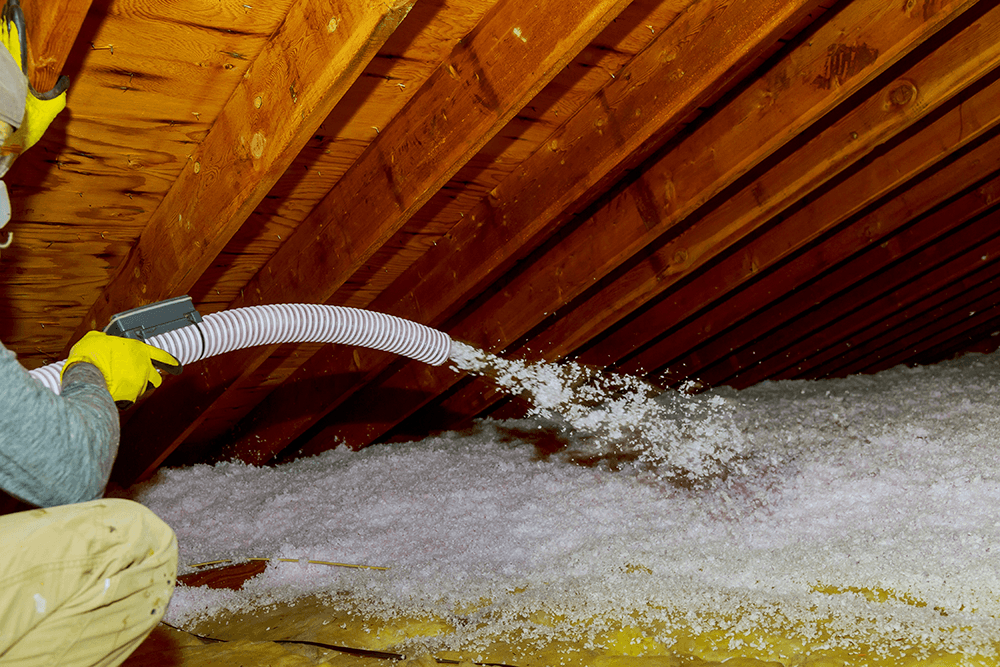 technician_spraying_blown_fiberglass_insulation