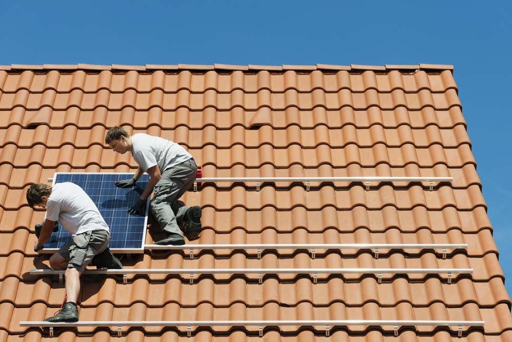 workers-installing-solar-panel-on-roof-framework-o-2021-11-16-18-40-45-utc